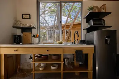 a kitchen with a counter with a sink and a window at SURÁ Playa Negra in Playa Negra