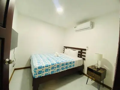 a bedroom with a bed with a blue and white bedspread at Bernis House with Jacuzzi in Tanque