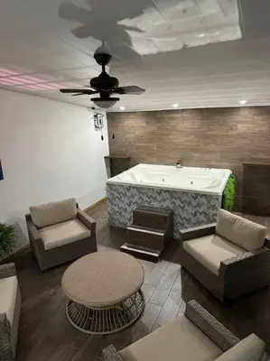 a living room with a tub and a table and chairs at Bernis House with Jacuzzi in Tanque