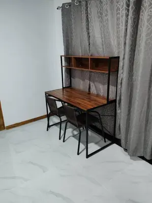 a wooden table with two chairs next to a curtain at Bernis House with Jacuzzi in Tanque