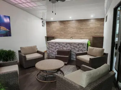 a patio with a bar with chairs and a table at Bernis House with Jacuzzi in Tanque