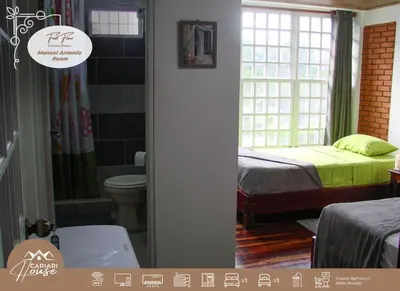 a bedroom with a bed and a bathroom with a toilet at Private rooms, 10 min from SJO Airport in Ciudad Cariari