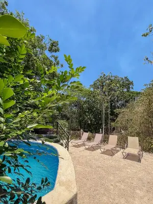a group of chairs sitting next to a swimming pool at Donde Chalo in Paquera