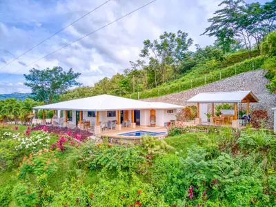 a house with a garden and a swimming pool at The Retreat at Blue Mountain Farms in Sámara