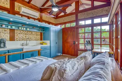 a bedroom with blue walls and a large bed at The Retreat at Blue Mountain Farms in Sámara