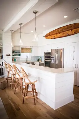 a kitchen with wooden stools and a white counter top at Diamante del Sol- 2 BR- Beach Front- Jaco in Jacó