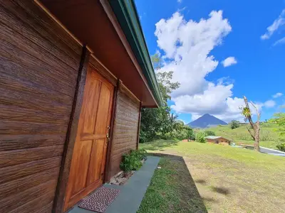 a wooden door on the side of a house at El Castillo Harmony in El Castillo de La Fortuna