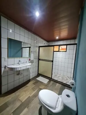 a bathroom with a toilet and a sink and a mirror at El Castillo Harmony in El Castillo de La Fortuna
