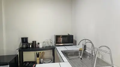 a kitchen with a sink and a microwave at El Castillo Harmony in El Castillo de La Fortuna