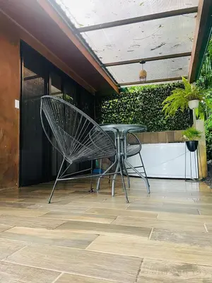 a table and a chair on a patio at El Castillo Harmony in El Castillo de La Fortuna
