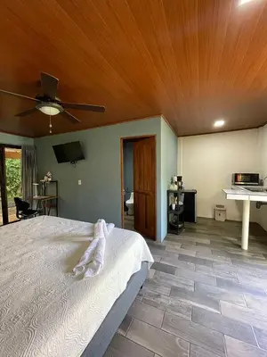 a bedroom with a bed with a wooden ceiling at El Castillo Harmony in El Castillo de La Fortuna