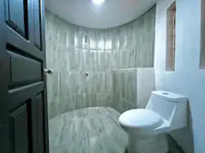 a bathroom with a white toilet in a room at Casa Plomo - 10 bed, 5 bdrm - One Block from Clubs in Jacó