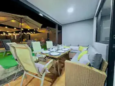 a dining room with a table and chairs at Casa Plomo - 10 bed, 5 bdrm - One Block from Clubs in Jacó