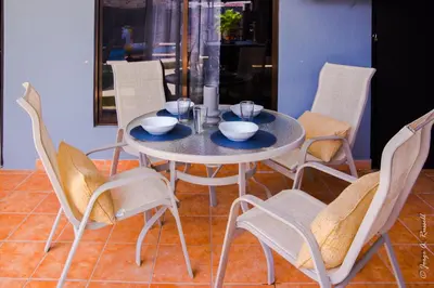 a dining table and chairs with a table and bowls on it at Casa Plomo - 10 bed, 5 bdrm - One Block from Clubs in Jacó