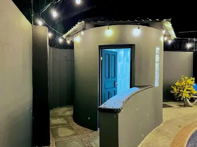 a house with a blue door with lights on it at Casa Plata & Casa Plomo in Jacó