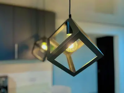 a chandelier with a star shaped light hanging at Casa Plata & Casa Plomo in Jacó