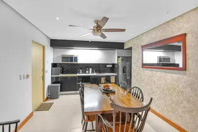 a kitchen and dining room with a wooden table at Luxury 2BR condo in Nautilus, Místico in Parrita