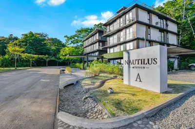a building with a sign in front of it at Luxury 2BR condo in Nautilus, Místico in Parrita