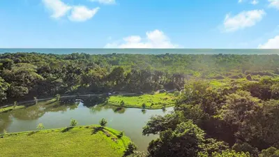 an aerial view of a river with trees at Luxury 2BR condo in Nautilus, Místico in Parrita