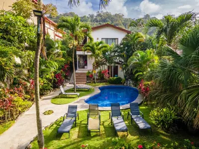 an image of a house with a swimming pool and chairs at Ola Bonita BeachFront Apart Hotel in Playa Hermosa