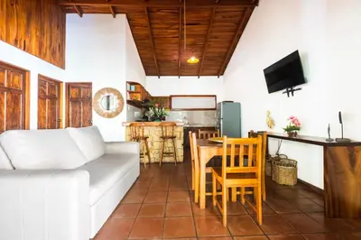 a living room with a couch and a table at Ola Bonita BeachFront Apart Hotel in Playa Hermosa
