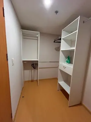 an attic room with a white book shelf at Moderno apartamento totalmente equipado in San José