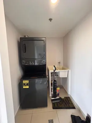 a television sitting on top of a refrigerator in a room at Moderno apartamento totalmente equipado in San José