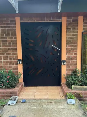 a black garage door with a painting on it at viajero solitario in Buenos Aires