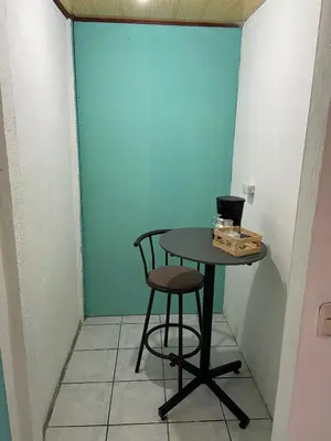 a table and a stool in a room with a blue wall at viajero solitario in Buenos Aires