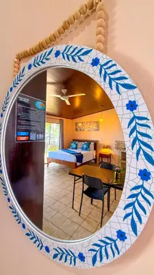 a mirror hanging on a wall with a room at Hotel Beachfront Vista Hermosa in Jacó