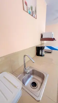 a kitchen counter with a sink and a toilet at Hotel Beachfront Vista Hermosa in Jacó