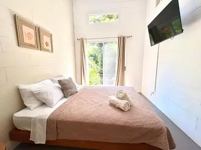 a bedroom with a bed with a teddy bear on it at Casa Jalapa with private pool in Uvita