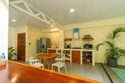 a kitchen with a table and chairs in a room at Casa Jalapa with private pool in Uvita