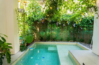 a swimming pool in the middle of a garden at Casa Jalapa with private pool in Uvita