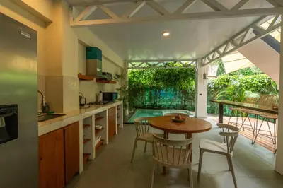 a kitchen with a table and chairs and a pool at Casa Jalapa with private pool in Uvita