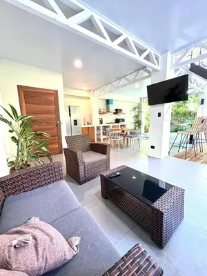 a living room with two couches and a tv at Casa Jalapa with private pool in Uvita