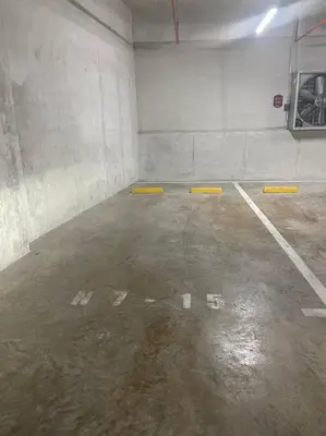 an empty parking garage with yellow frisbees in it at Studio Sabana Secrt 3011 in San José