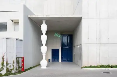 a building with a blue door and a white vase at Studio Sabana Secrt 3011 in San José