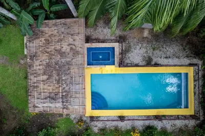 a swimming pool on the side of a building at Spacious 3-Bedroom Coastal Home with Shared Pool, Outdoor Living & Steps to Playa Potrero in Potrero