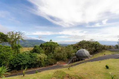 a house with a dome on the side of a road at Cabañas de Montaña Magia del Poás in Poás