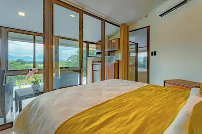 a bedroom with a large bed with a large window at Hotel La Hacienda in Quesada