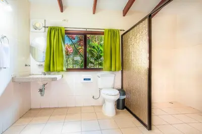a bathroom with a toilet and a window at Hotel La Hacienda in Quesada