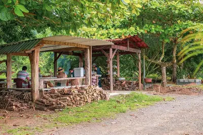 a wooden pavilion with people sitting at a table at Hotel La Hacienda in Quesada