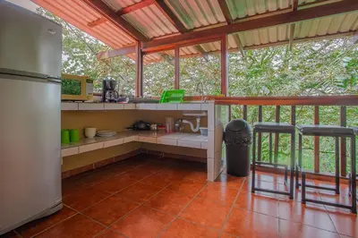 a kitchen with a counter and a refrigerator in a room at Hotel La Hacienda in Quesada