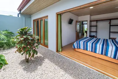 a bedroom with a bed on a wooden deck at Casa Luna in Tanque