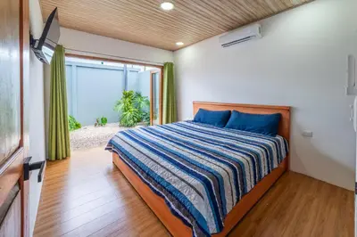a bedroom with a bed and a large window at Casa Luna in Tanque