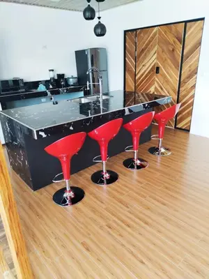 a bar with red bar stools in a kitchen at Casa Luna in Tanque