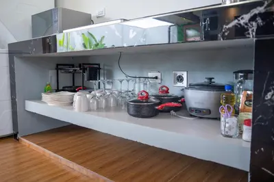 a kitchen shelf with dishes and other items on it at Casa Luna in Tanque