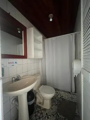 a bathroom with a sink and a toilet at Gaudy's Hostel in San José