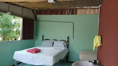 a bedroom with a bed in a room with a window at Árbol de mayo in Jiménez